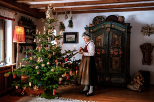 Christmas in an idyllic parlor, grandma in traditional costume Christmas in an idyllic parlor, grandma in traditional costume